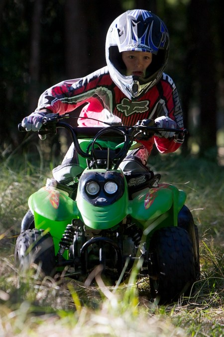 Child on ATV Sport/action photo of child riding an ATV quad bike.